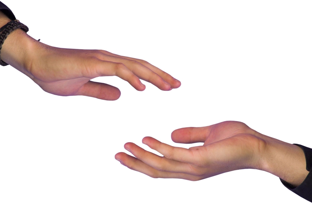 two hands reaching out to each other